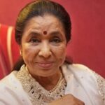 Asha Ji Bhoshle smiling, legendary Indian playback singer and global icon.