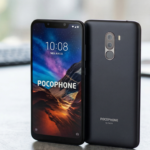 A front and back product shot of the Graphite Black Poco F1 with 845 Snapdragon on a desk, highlighting the large notch and vertical dual cameras.